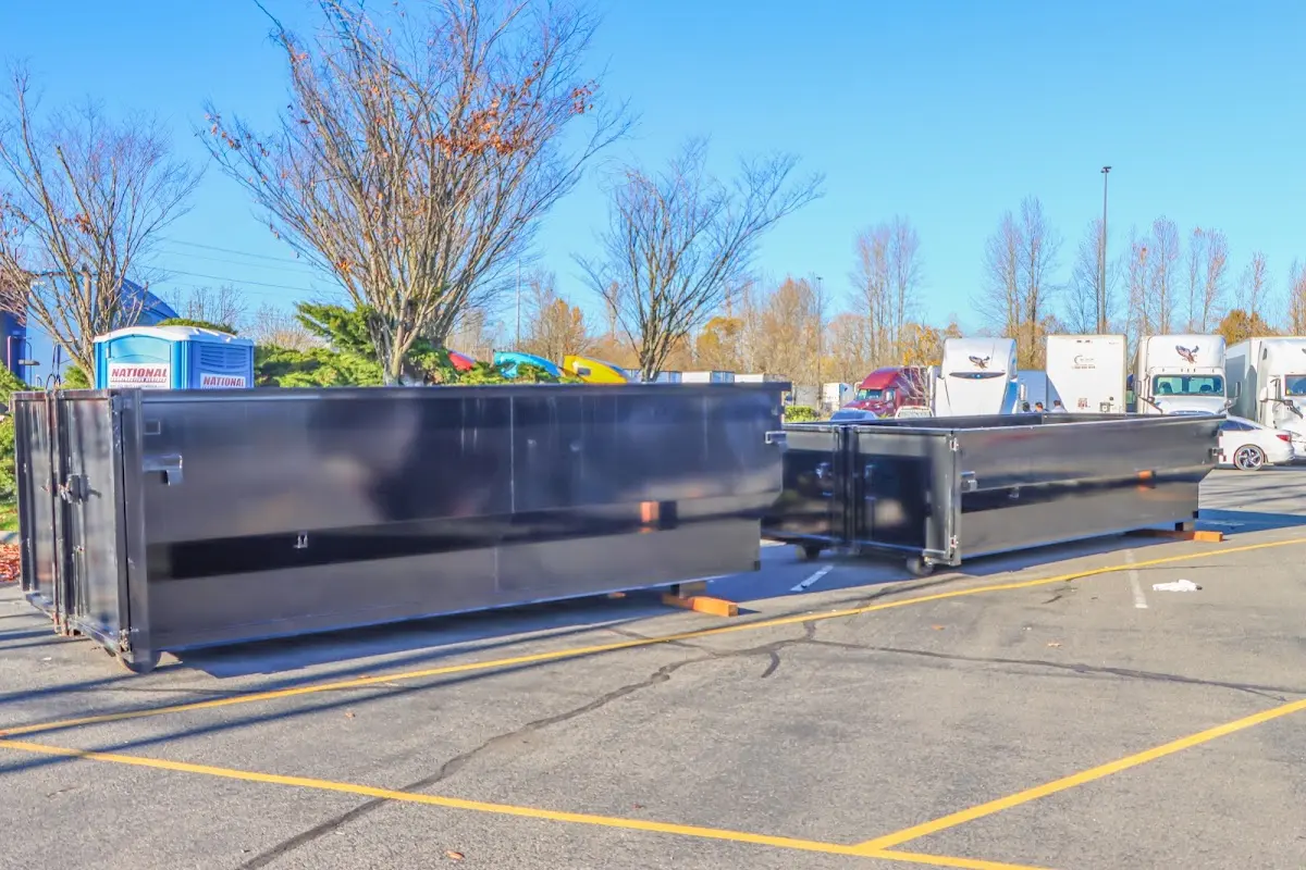 Professional dumpster rental service with roll-off container on residential driveway in Airmont